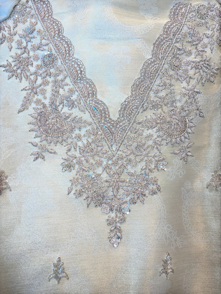 Design by Pakiza ivory pure tissue shirt with intricate gold dabka, sequin, and beadwork embroidery on the neckline.