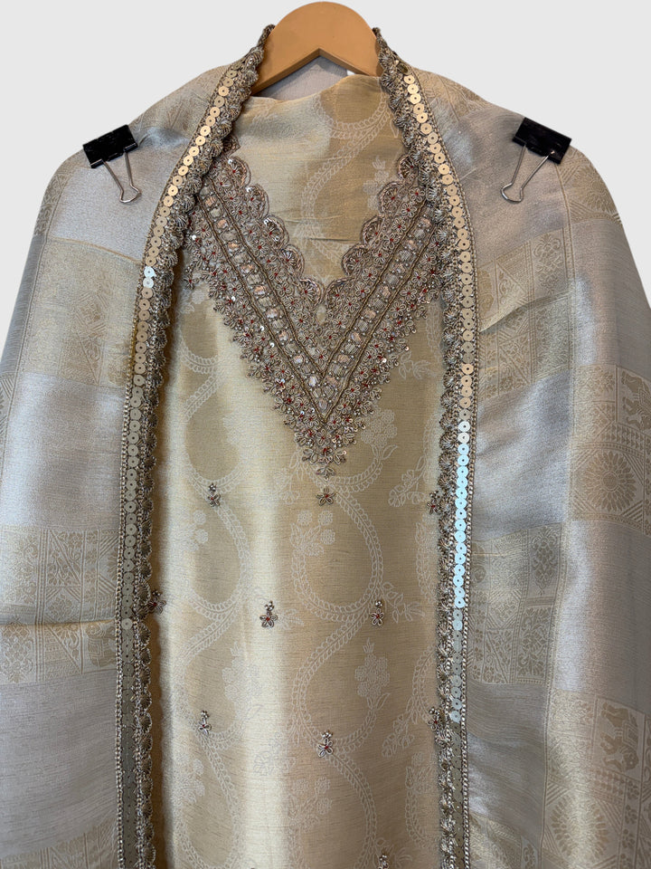 Design by Pakiza ivory gold pure tissue 3-piece suit with intricate dabka, sequin, and beadwork on the neckline.