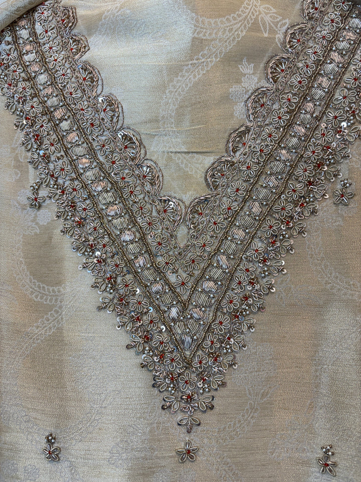 Design by Pakiza ivory pure tissue shirt featuring intricate gold dabka, sequin, and beadwork on the V-neckline.