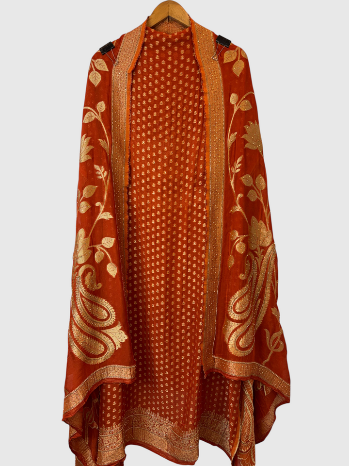 Design by Pakiza orange khadi georgette Banarasi suit set with gold woven booties, beadwork, and floral dupatta