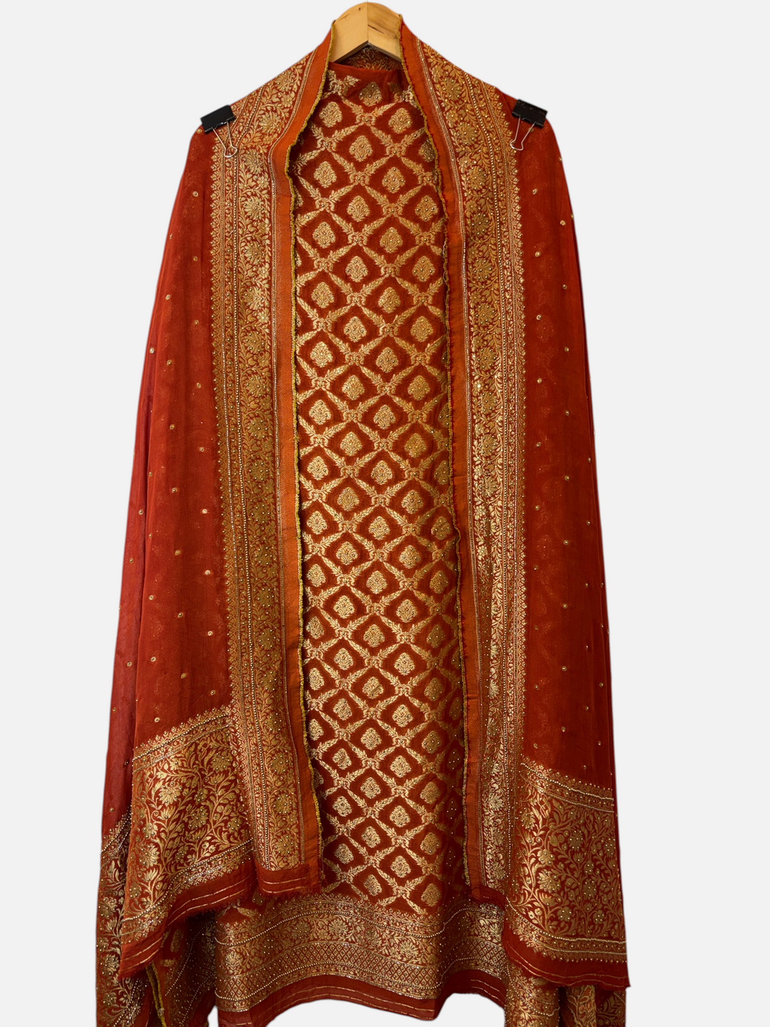 Design by Pakiza rust Khadi Georgette unstitched suit with gold Banarasi jaal, stone embellishments, and dupatta