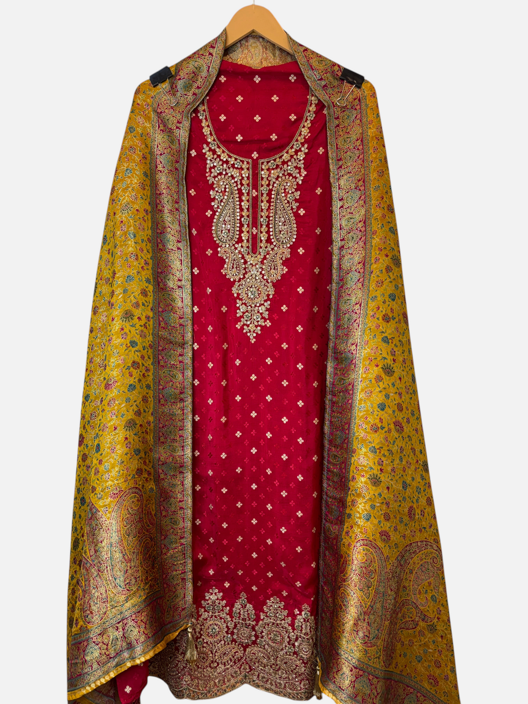 Design by Pakiza red silk Banarasi suit with intricate zari, sequin, and stone work paired with a yellow woven dupatta