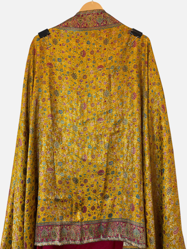Design by Pakiza yellow silk fabric with intricate Banarasi woven floral patterns and embellished border