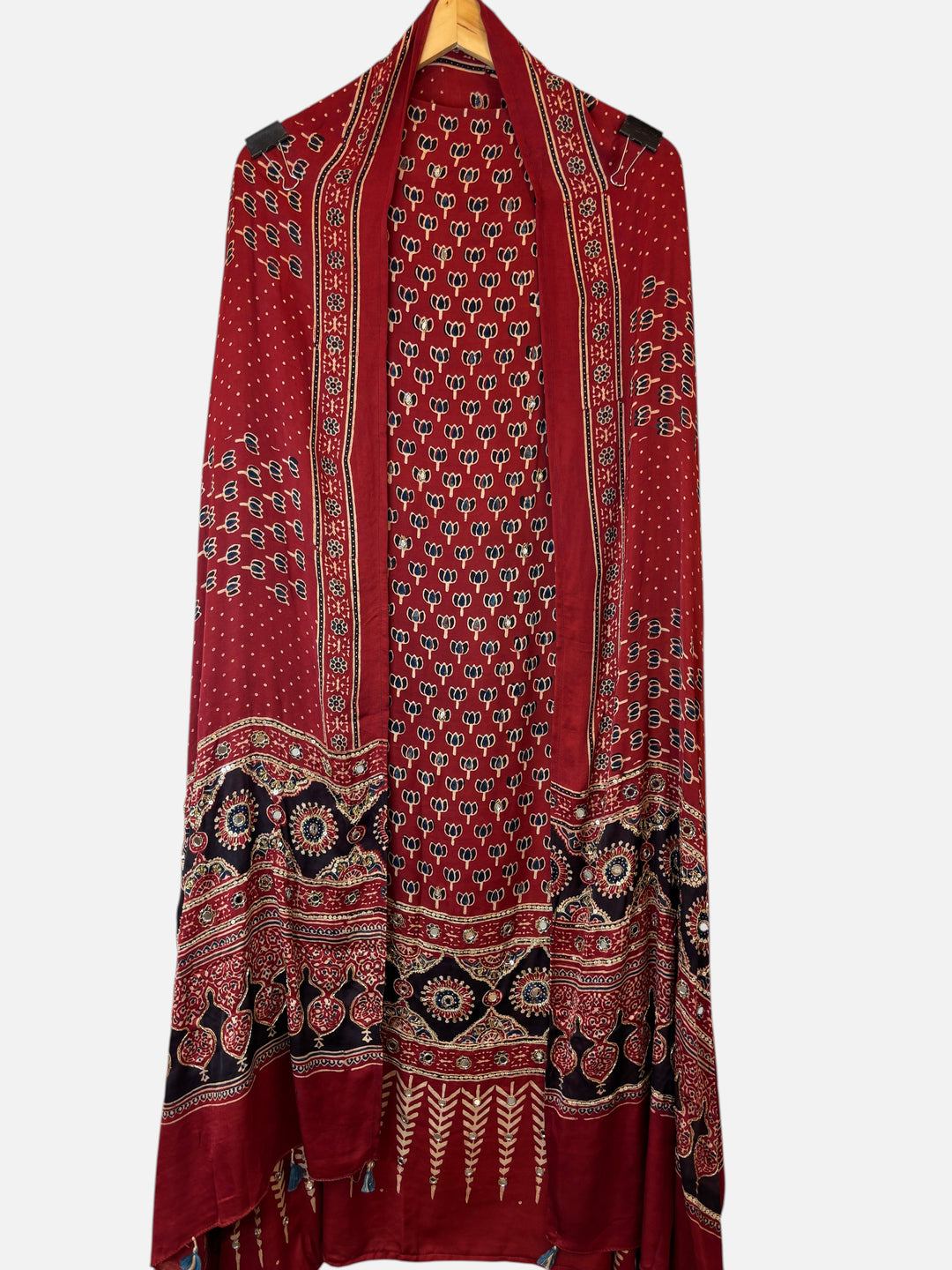 Design by Pakiza red modal Ajrakh dupatta with intricate lotus print, mirror work, and tassel details.