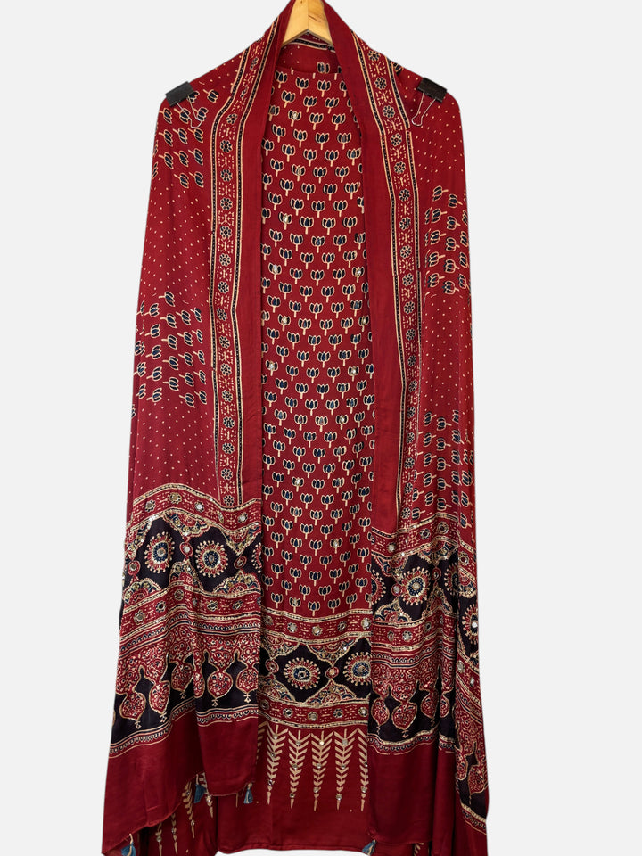 Design by Pakiza red modal Ajrakh dupatta with intricate lotus print, mirror work, and tassel details.