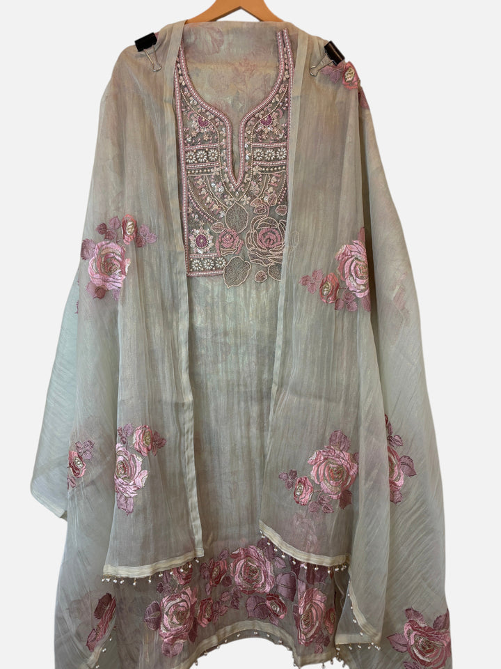 Design by Pakiza crush tissue 3-piece ensemble with pearl, bead, and zari floral embroidery on a beige fabric.