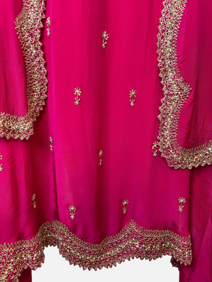 Design by Pakiza fuchsia pure crepe fabric with intricate gold cutdana, sequin, and pearl embroidery and cutwork border