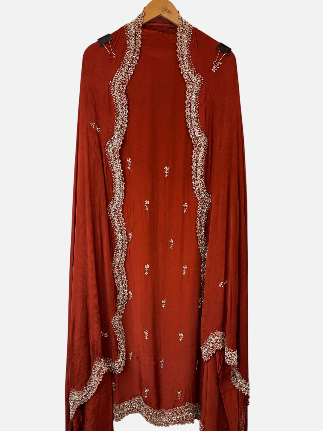 Design by Pakiza rust red crepe dupatta with intricate cutwork borders, pearl, sequin, and cutdana embellishments.
