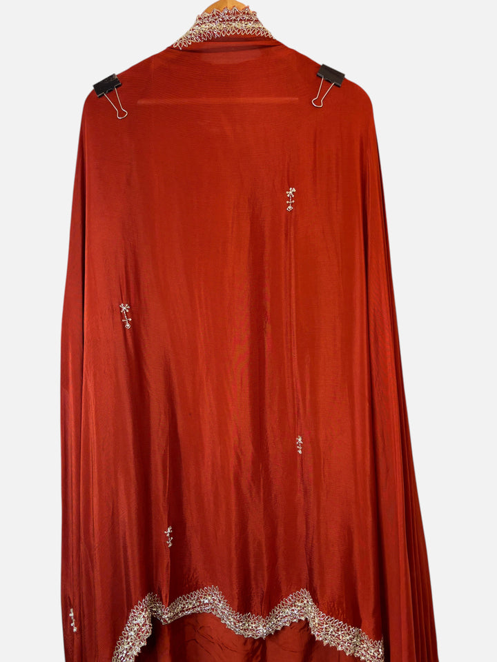 Design by Pakiza rust red crepe fabric with intricate cutdana, sequin, and pearl embroidery and cutwork border