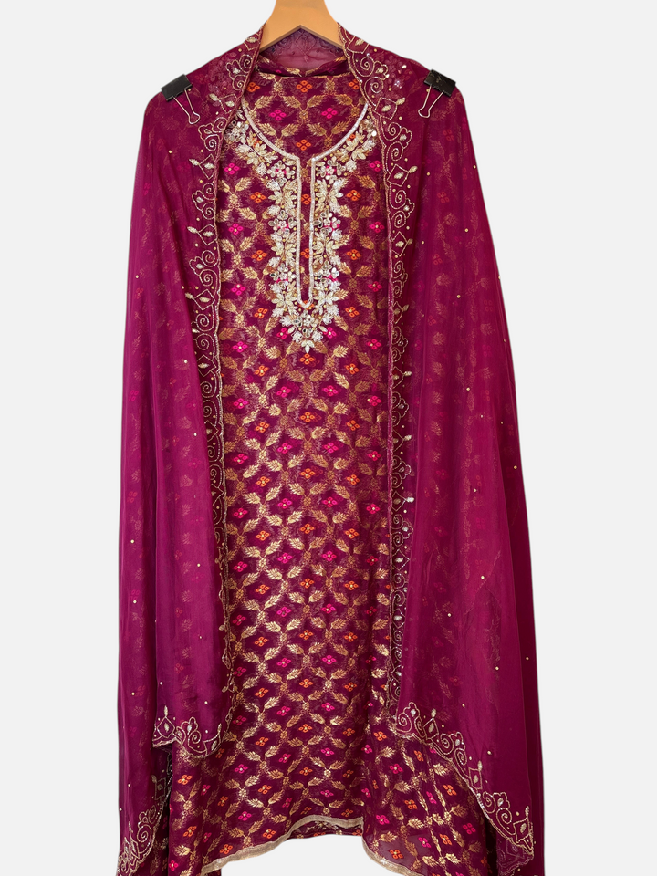 Design by Pakiza wine khadi georgette Banarasi ensemble with intricate dabka, sequin, and mirror embellished neckline.