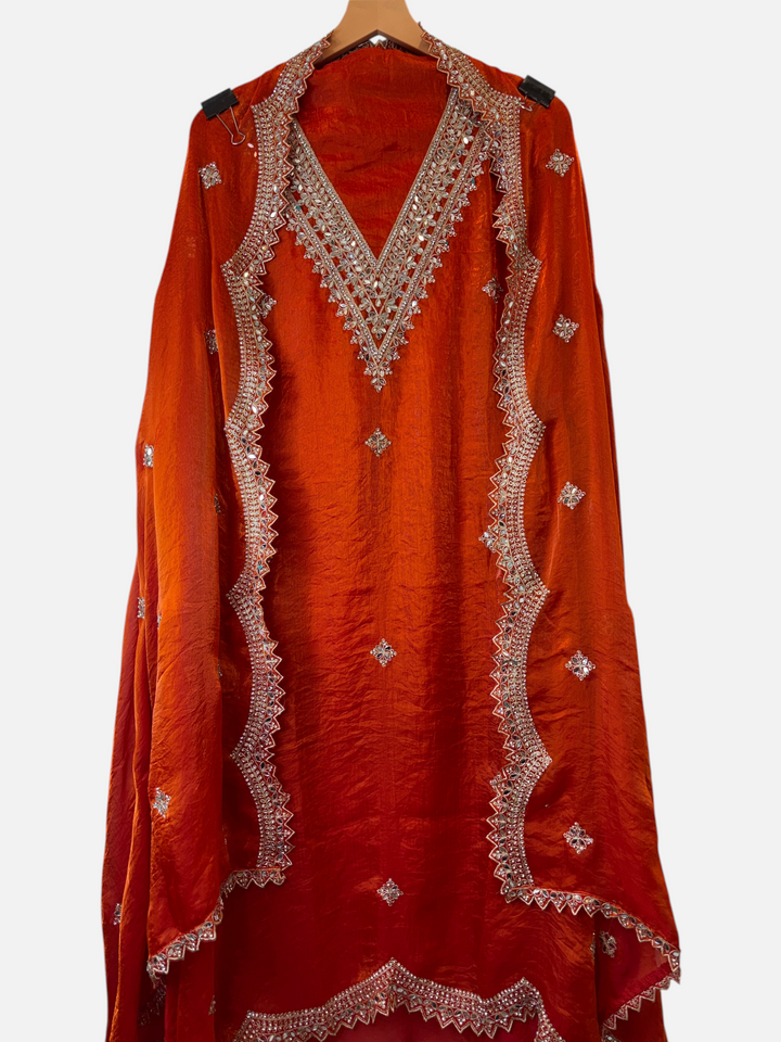 Design by Pakiza orange glass organza shirt with intricate mirror and stone work on the v-neckline and hem