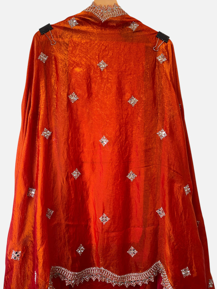 Design by Pakiza orange glass organza fabric with intricate mirror and stone work detailing for a festive ensemble.