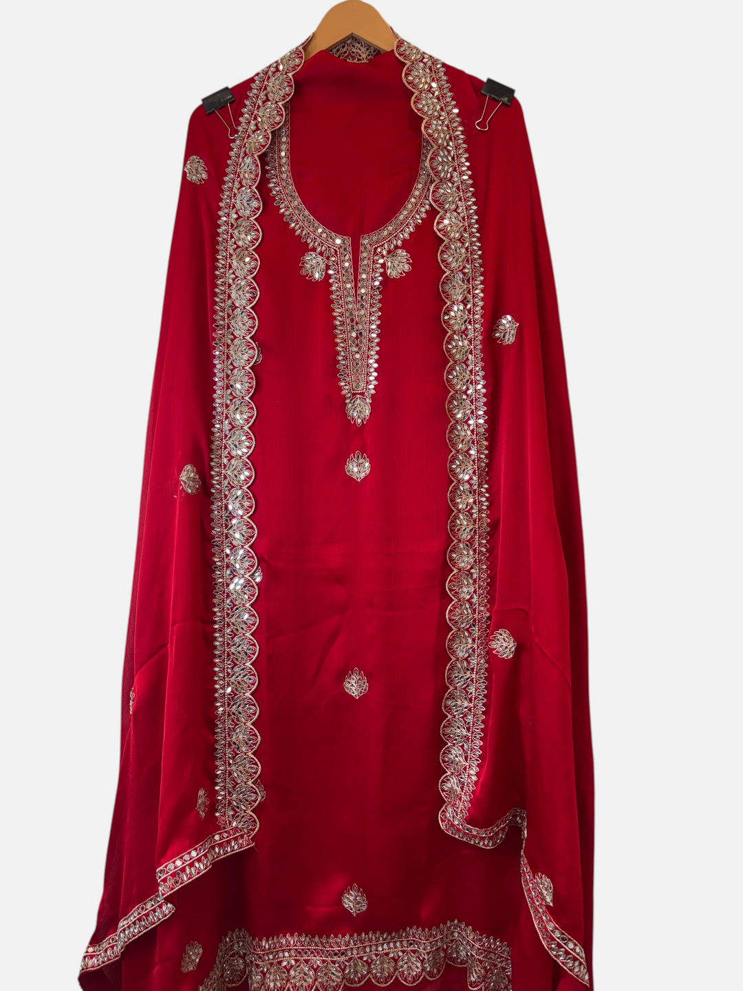 Design by Pakiza red Chinon organza ensemble with intricate zari and mirror work on the neckline and dupatta edges.