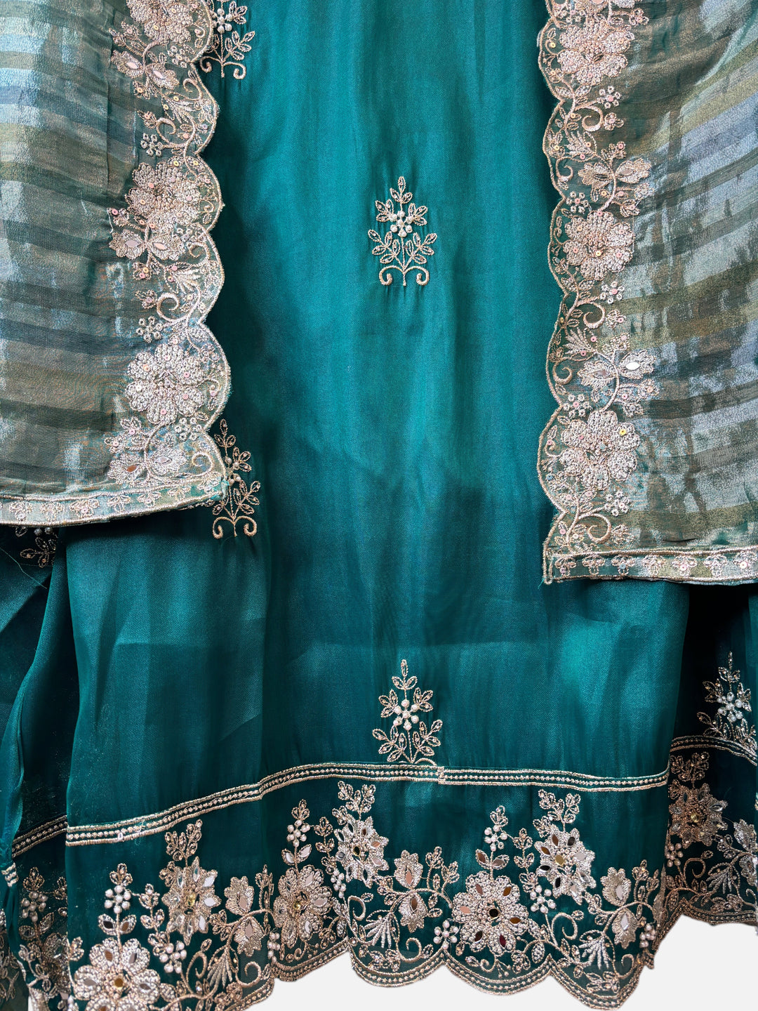 Design by Pakiza teal glass organza ensemble with intricate zari, pearl, and sequin embellishments and cutwork dupatta.
