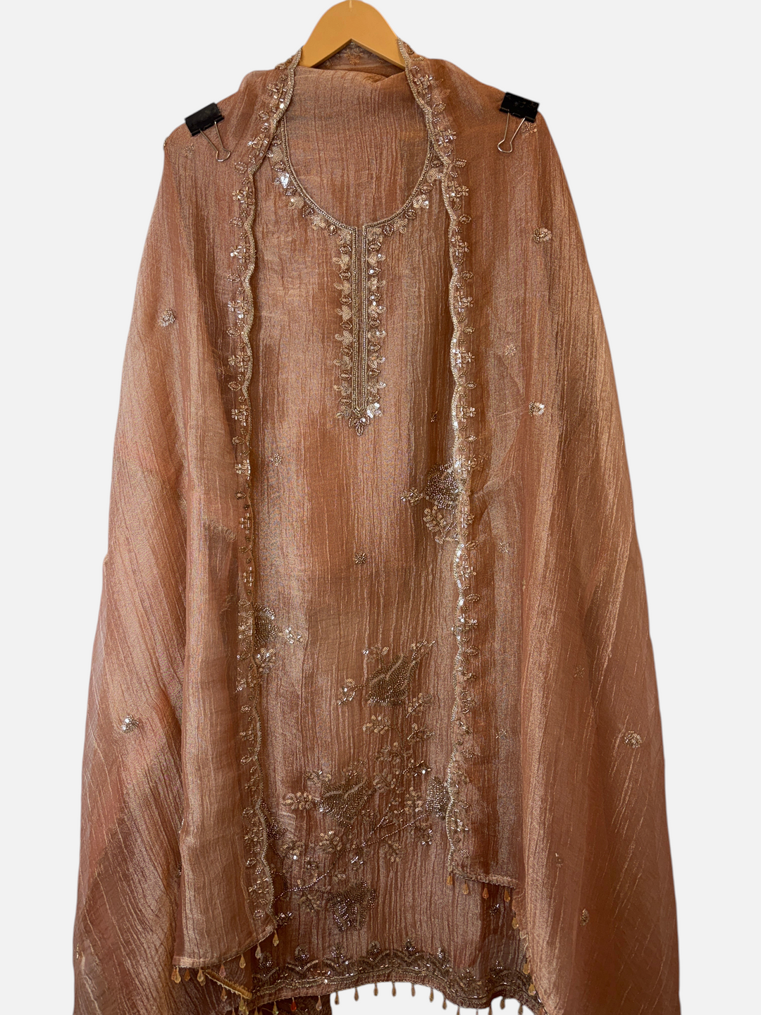 Design by Pakiza copper crush tissue shirt with intricate zari, sequin, and bead embellishments and tassel hem.
