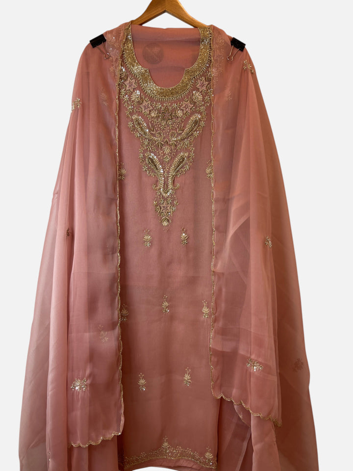 Design by Pakiza peach tissue 3-piece ensemble with intricate zari, pearl, and sequin embroidery on the neckline.