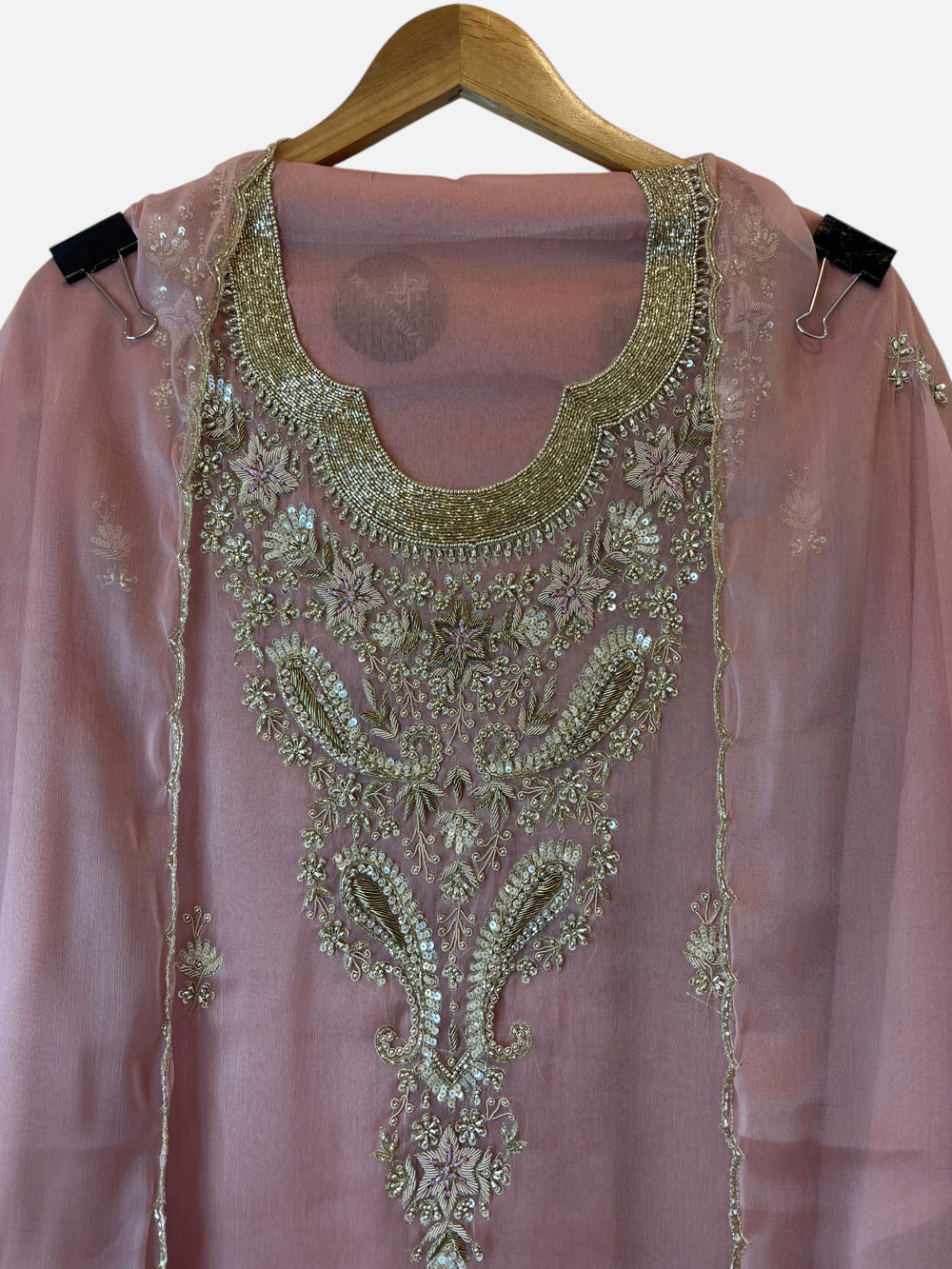 Design by Pakiza pink tissue shirt with intricate gold zari, pearl, sequin, and bead embroidery on the neckline.