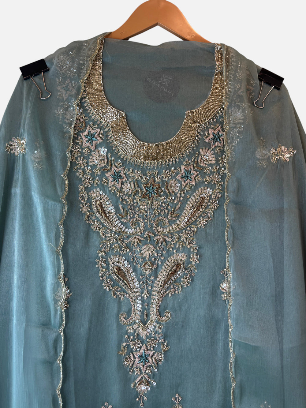 Design by Pakiza Ameera tissue ensemble with intricate zari, pearl, and sequin embroidery on a soft teal fabric.