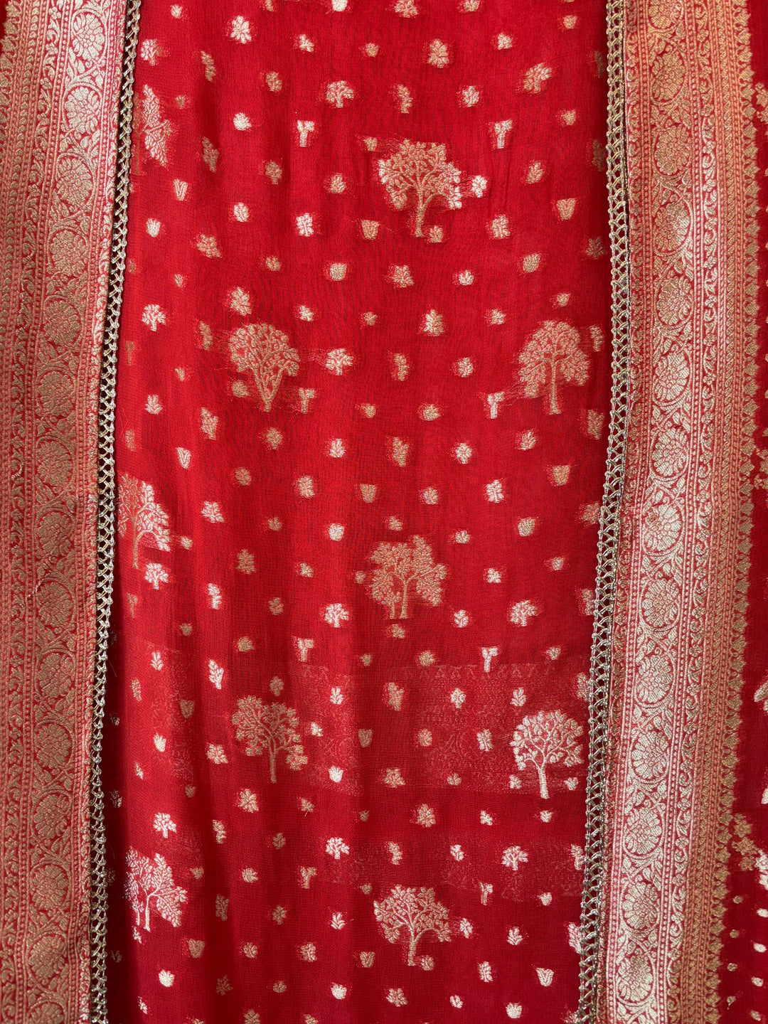 Design by Pakiza orange khadi georgette fabric with intricate gold Banarasi woven tree motifs and elegant lace trim