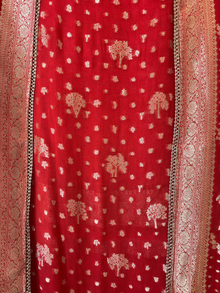 Design by Pakiza orange khadi georgette fabric with intricate gold Banarasi woven tree motifs and elegant lace trim