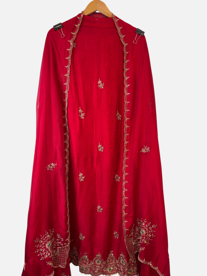 Design by Pakiza red silk organza ensemble with intricate zardozi, dabka, and sequin embroidery on a hanging dupatta