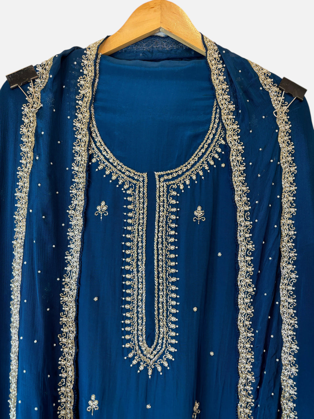 Design by Pakiza teal blue crepe suit featuring intricate cutdana and pearl handwork on the neckline and dupatta.