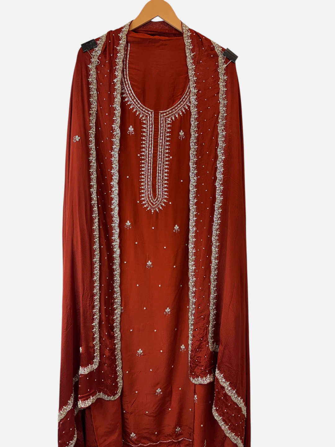 Design by Pakiza rust red crepe 3-piece suit with pearl and cutdana handwork, featuring an embellished chinon dupatta.