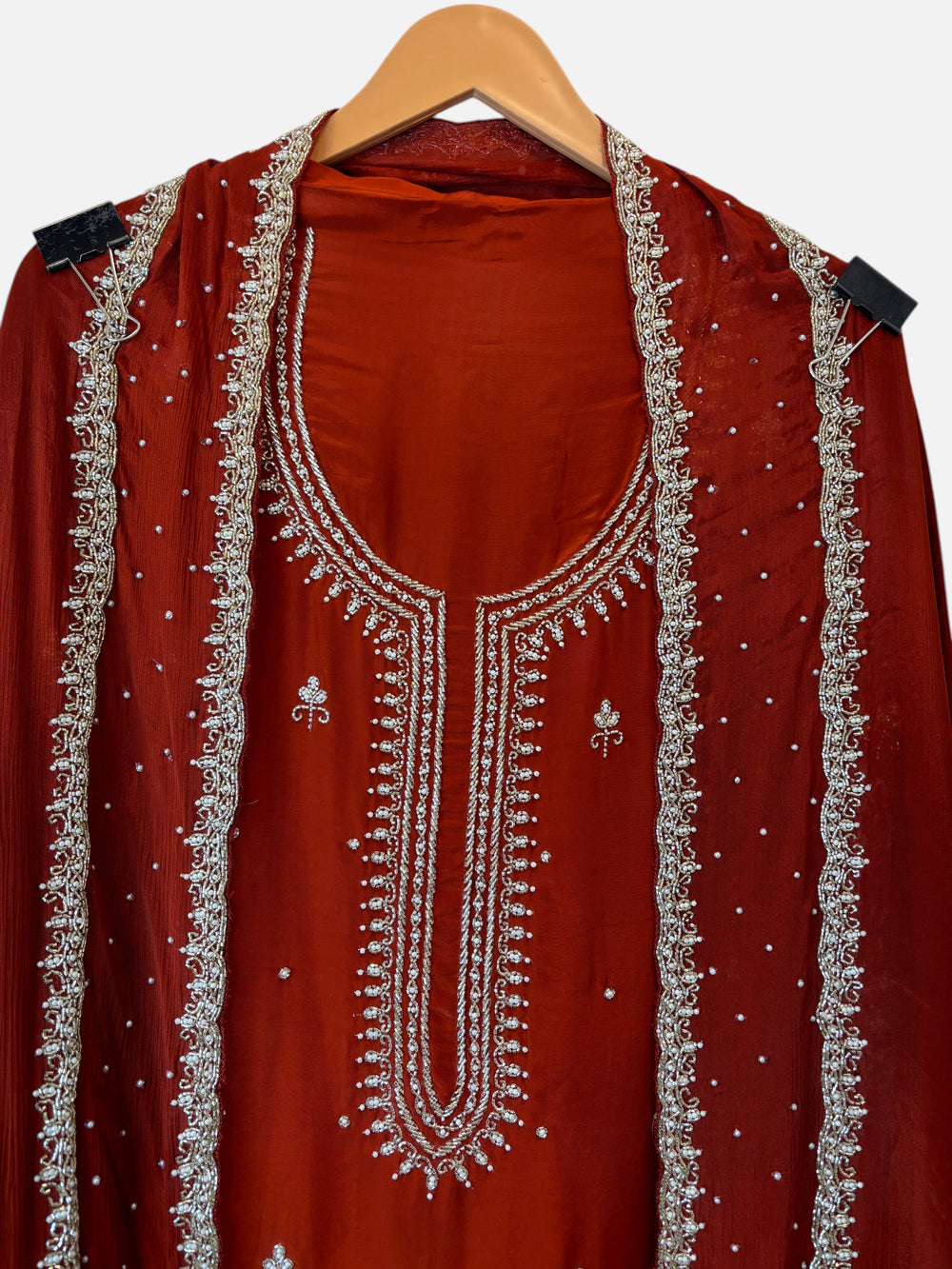 Design by Pakiza rust red crepe 3-piece suit with intricate pearl and cutdana handwork on shirt and chinon dupatta