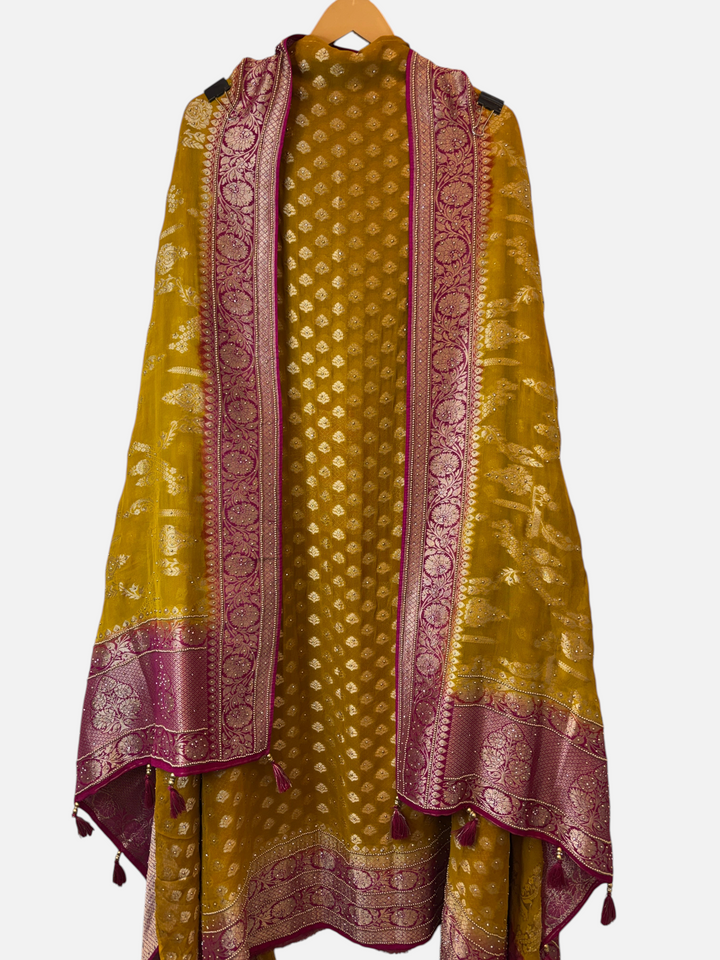 Design by Pakiza mustard yellow khadi georgette suit with gold motifs and a magenta Banarasi weave dupatta with tassels