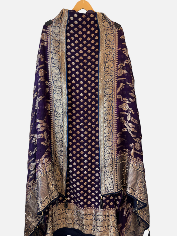 Design by Pakiza purple khadi georgette suit with intricate multi-gold jaal patterns and elegant tassel embellishments