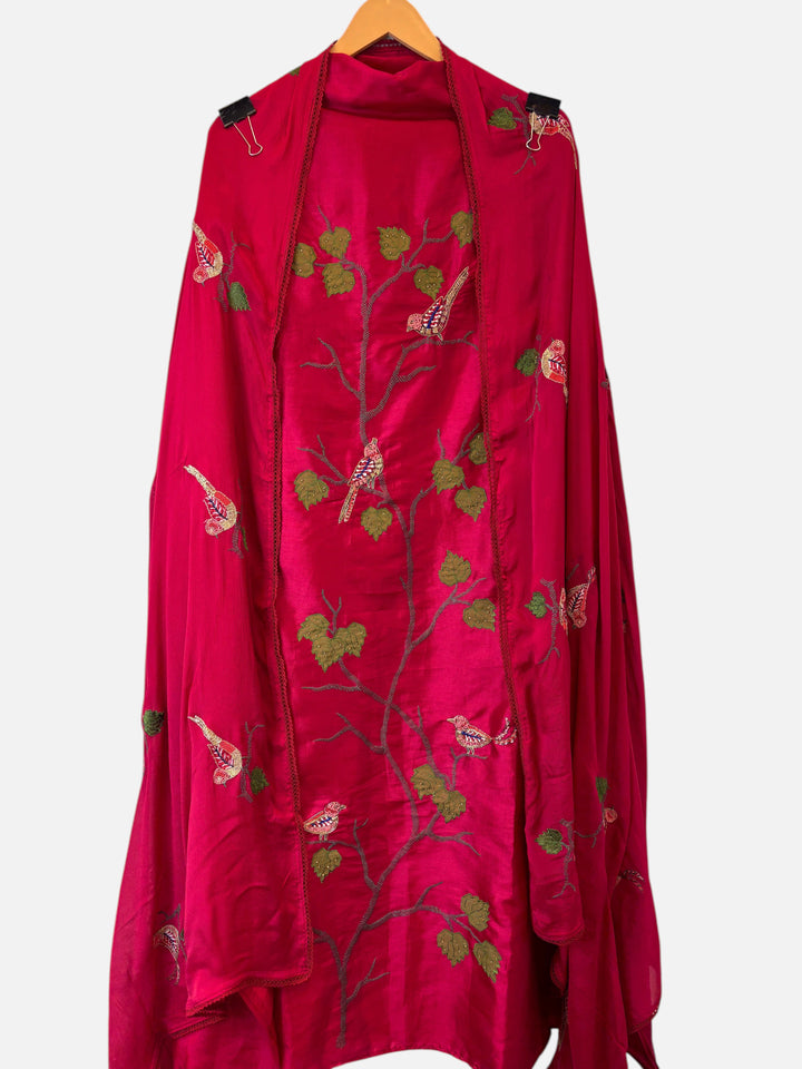Design by Pakiza rani pink silk suit featuring intricate bird appliqué, dabka embroidery, and beadwork details.