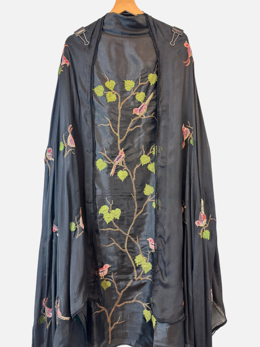 Design by Pakiza black silk ensemble featuring intricate bird appliqué, dabka embroidery, and beadwork on a dupatta