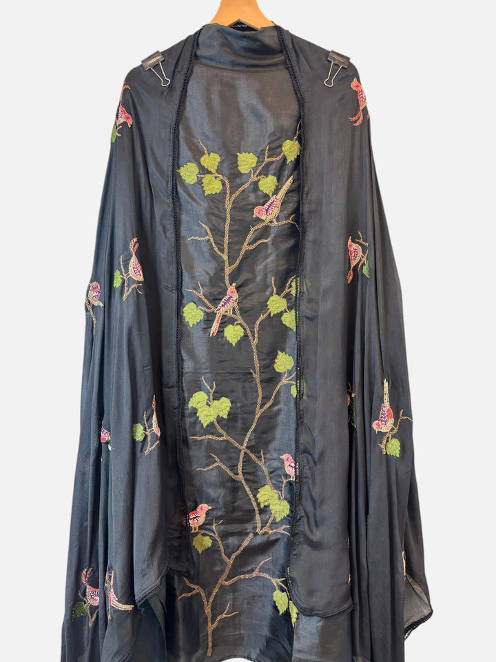 Design by Pakiza black silk ensemble featuring intricate bird appliqué, dabka embroidery, and beadwork on a dupatta