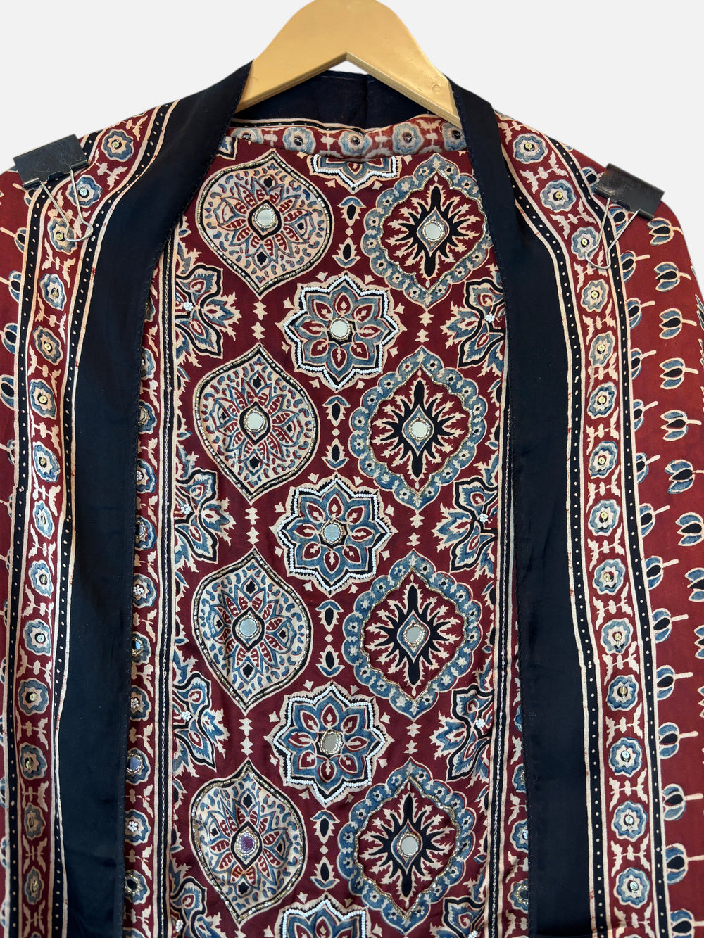 Design by Pakiza deep wine red Ajrakh modal shirt with intricate lotus block prints and cutdana embellishments.