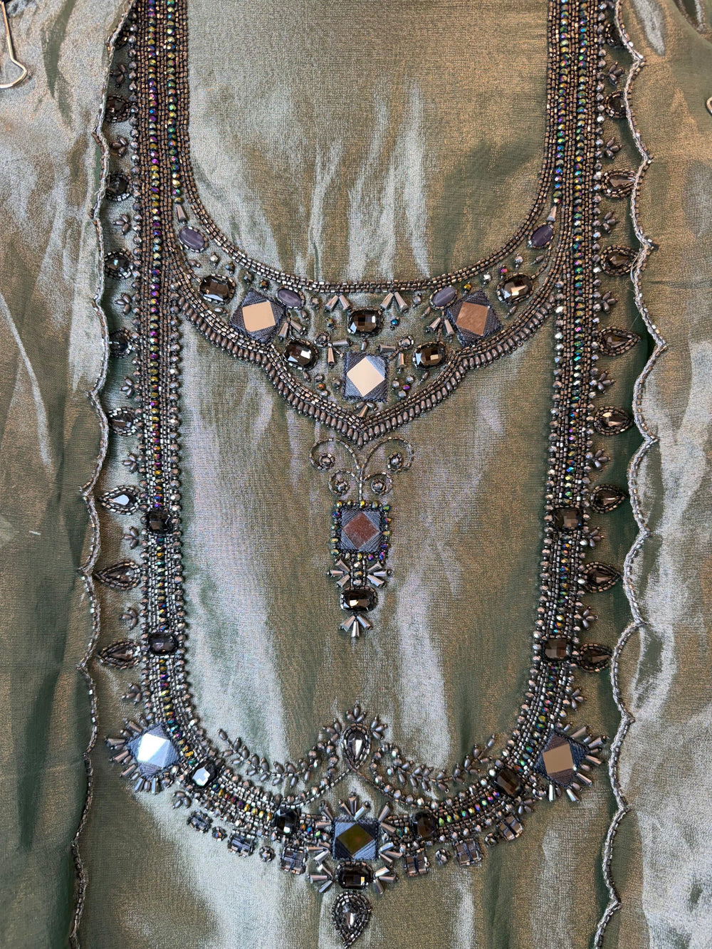 Design by Pakiza Kanjivaram shirt with intricate dori, sequin, and stone embellishments in a sage green hue.